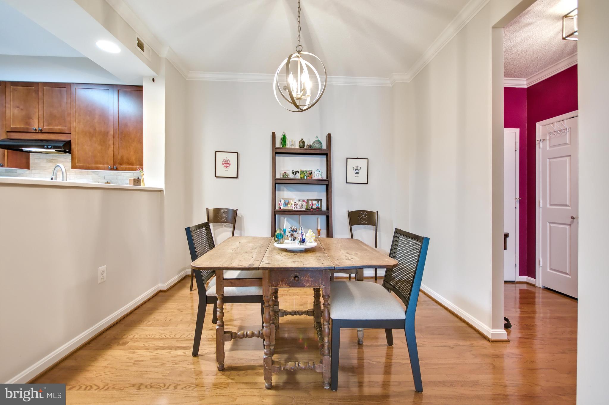 940 Astern Way, Unit 309 Annapolis, MD 21401 - Photo 7 of 52 a view of a dining room with furniture wooden floor and chandelier