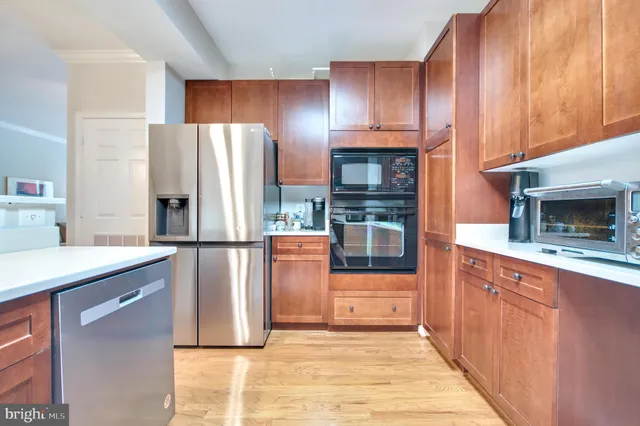 a kitchen with stainless steel appliances granite countertop a refrigerator a stove a sink and a refrigerator