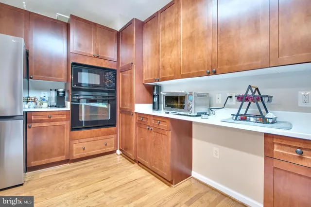 a kitchen with stainless steel appliances granite countertop a sink and cabinets