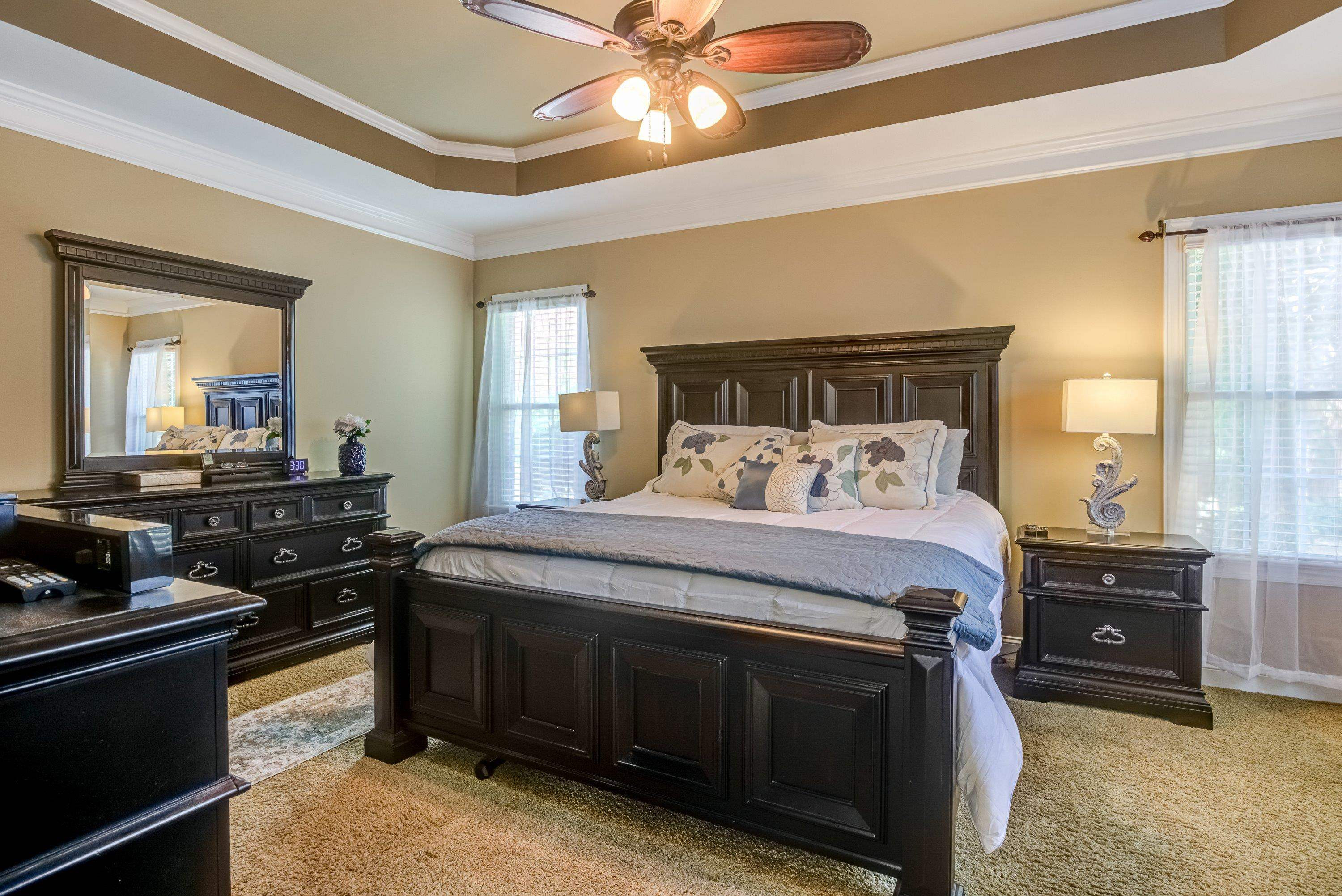 1911 Hornbeck Court Raleigh, NC 27614 - Photo 22 of 47 a bedroom with a bed and a chandelier