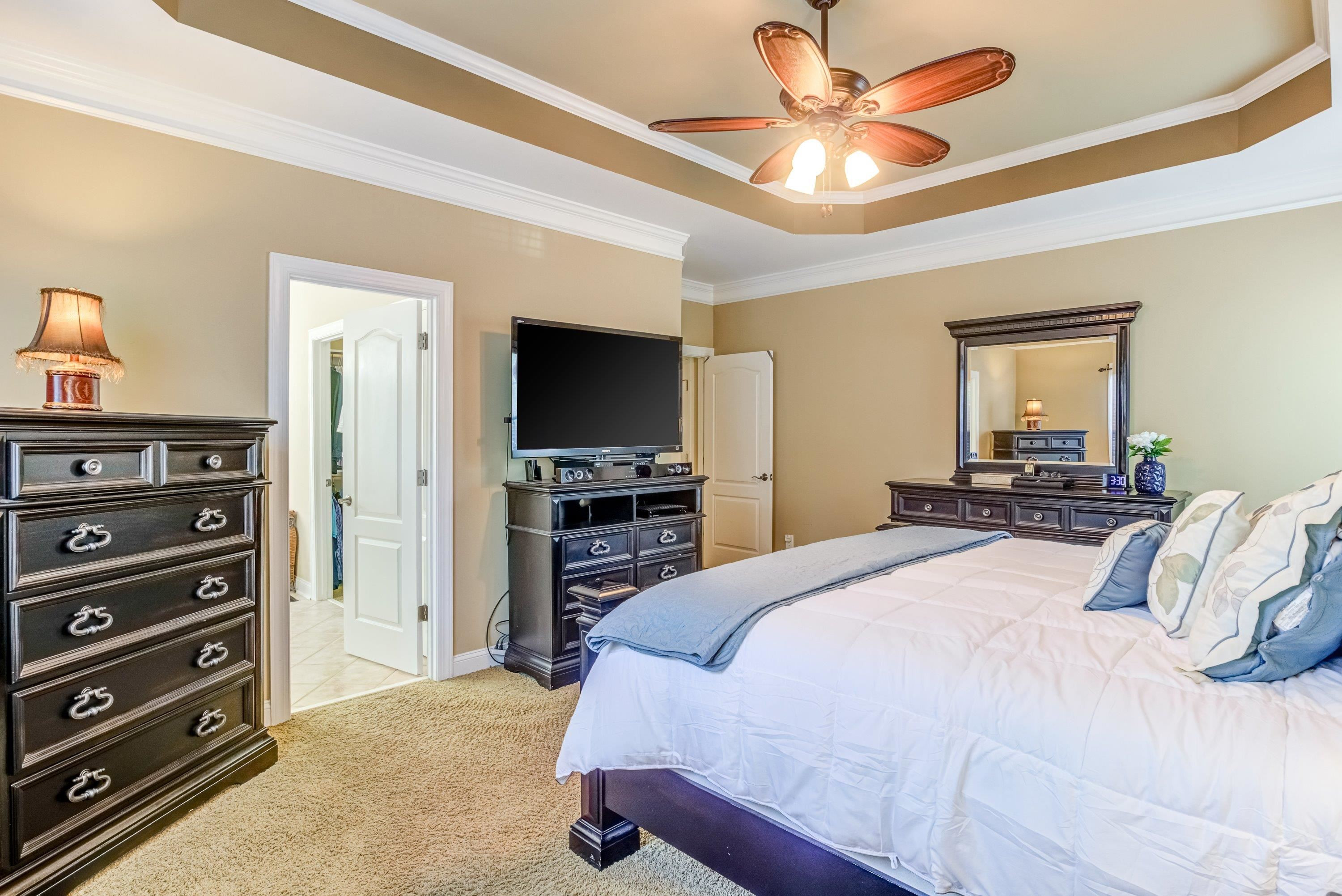 1911 Hornbeck Court Raleigh, NC 27614 - Photo 23 of 47 a bedroom with a bed and a flat tv screen on dresser