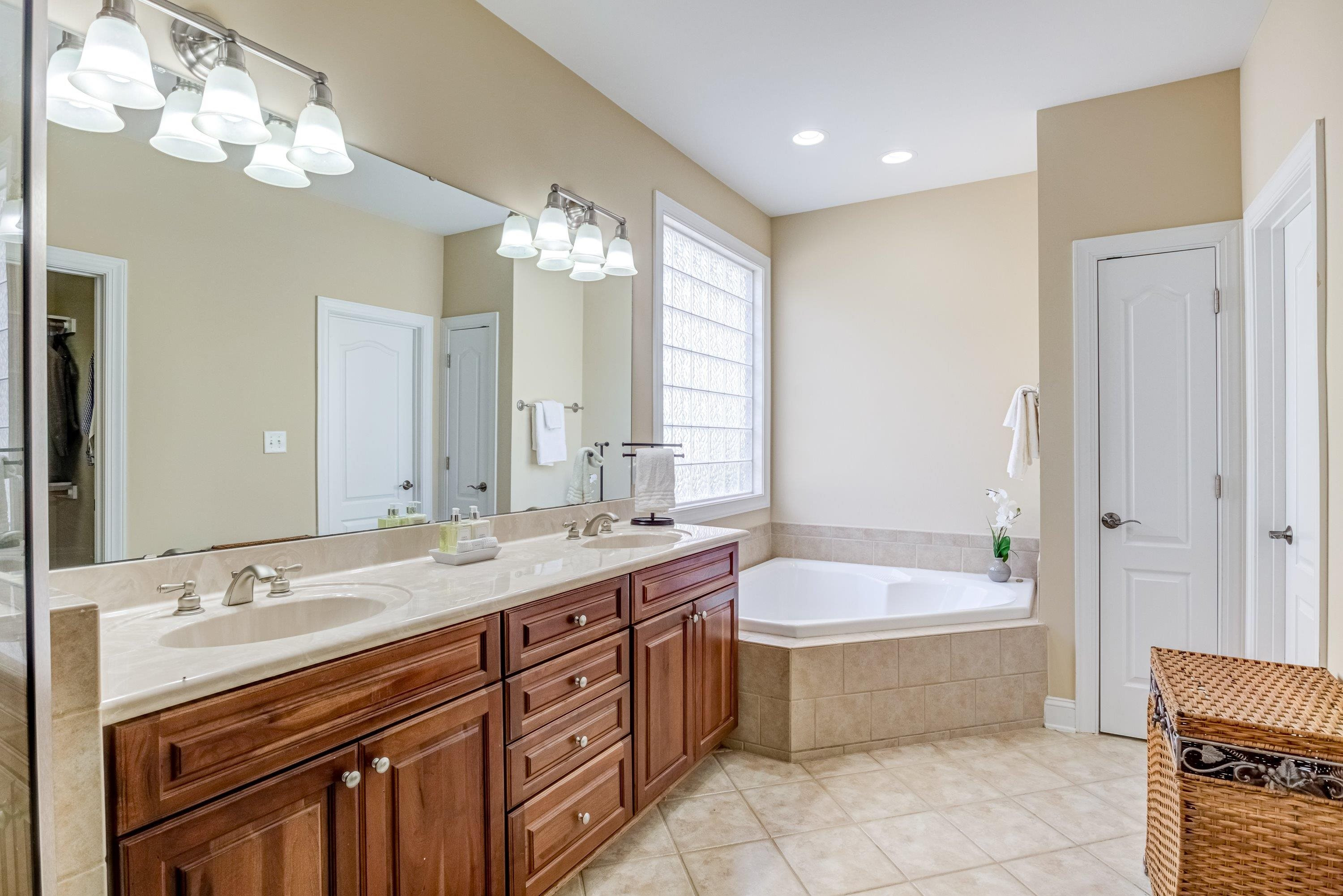 1911 Hornbeck Court Raleigh, NC 27614 - Photo 24 of 47 a spacious bathroom with a double vanity sink large mirror and a bathtub