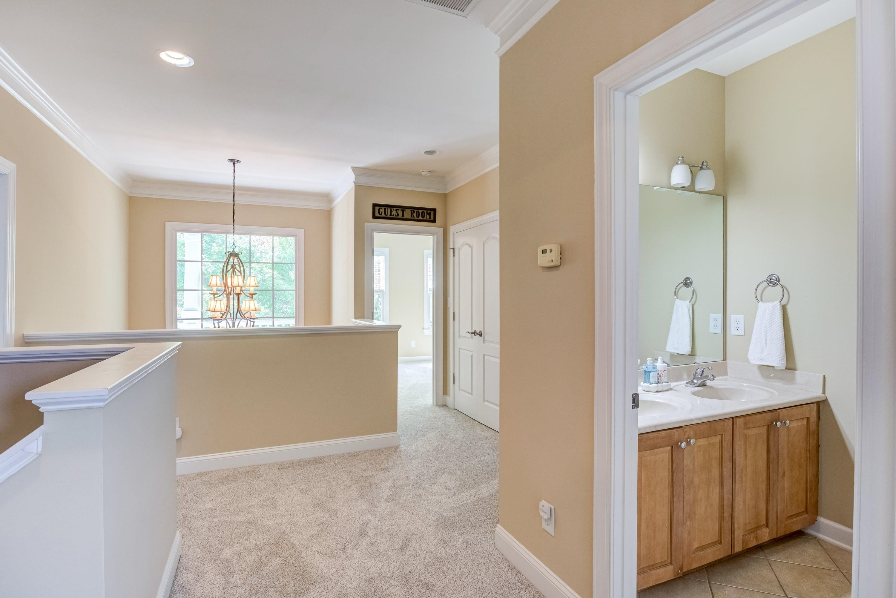 1911 Hornbeck Court Raleigh, NC 27614 - Photo 27 of 47 a bathroom with a granite countertop sink a large mirror and a bathtub