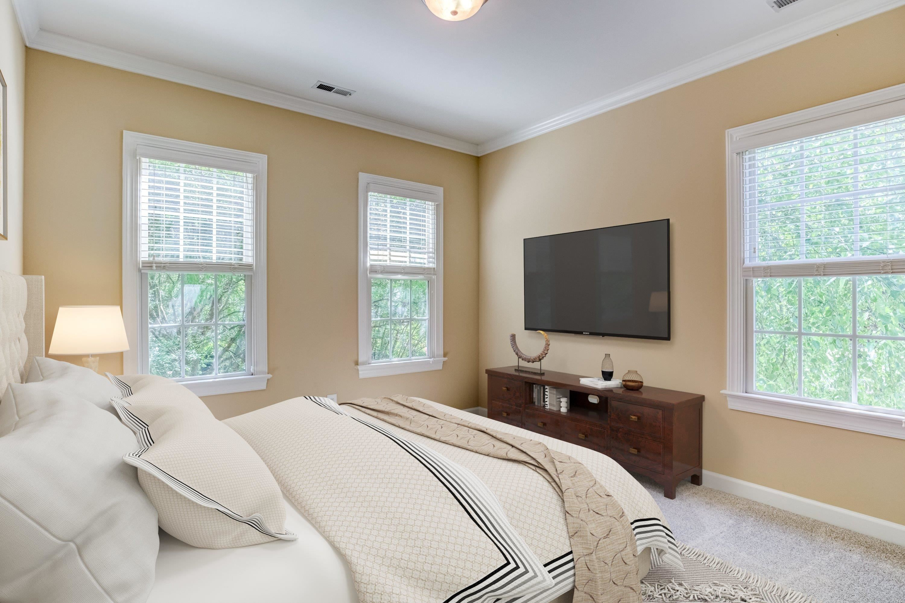 1911 Hornbeck Court Raleigh, NC 27614 - Photo 30 of 47 a bedroom with a bed and a flat tv screen next to a window