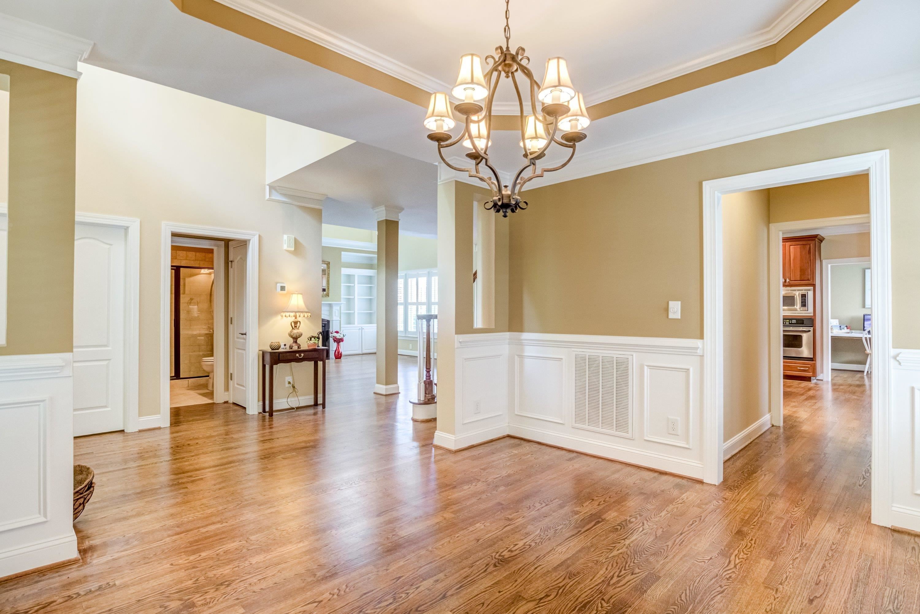 1911 Hornbeck Court Raleigh, NC 27614 - Photo 8 of 47 a view of a livingroom with wooden floor and a chandelier