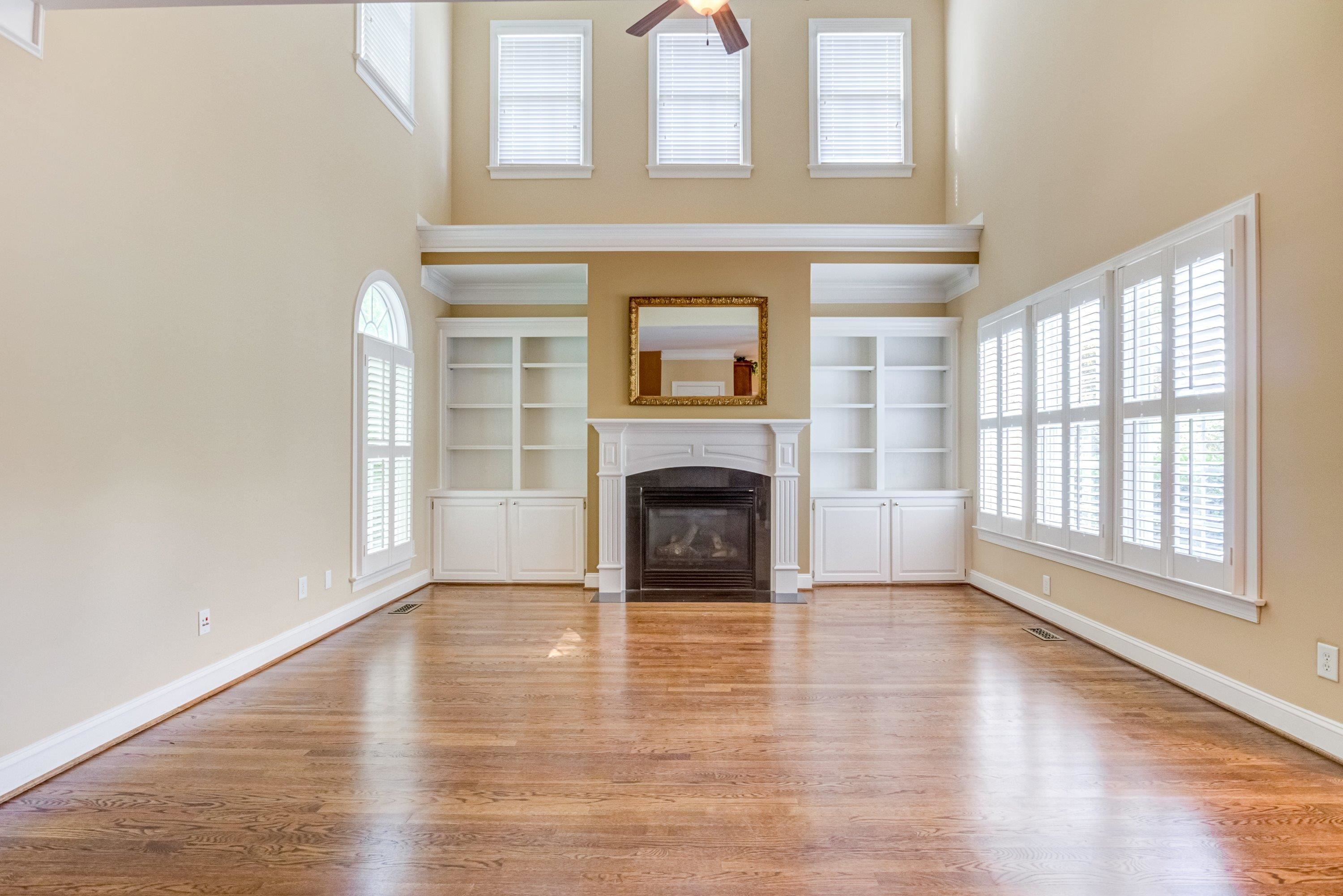 1911 Hornbeck Court Raleigh, NC 27614 - Photo 10 of 47 an empty room with wooden floor fireplace and windows