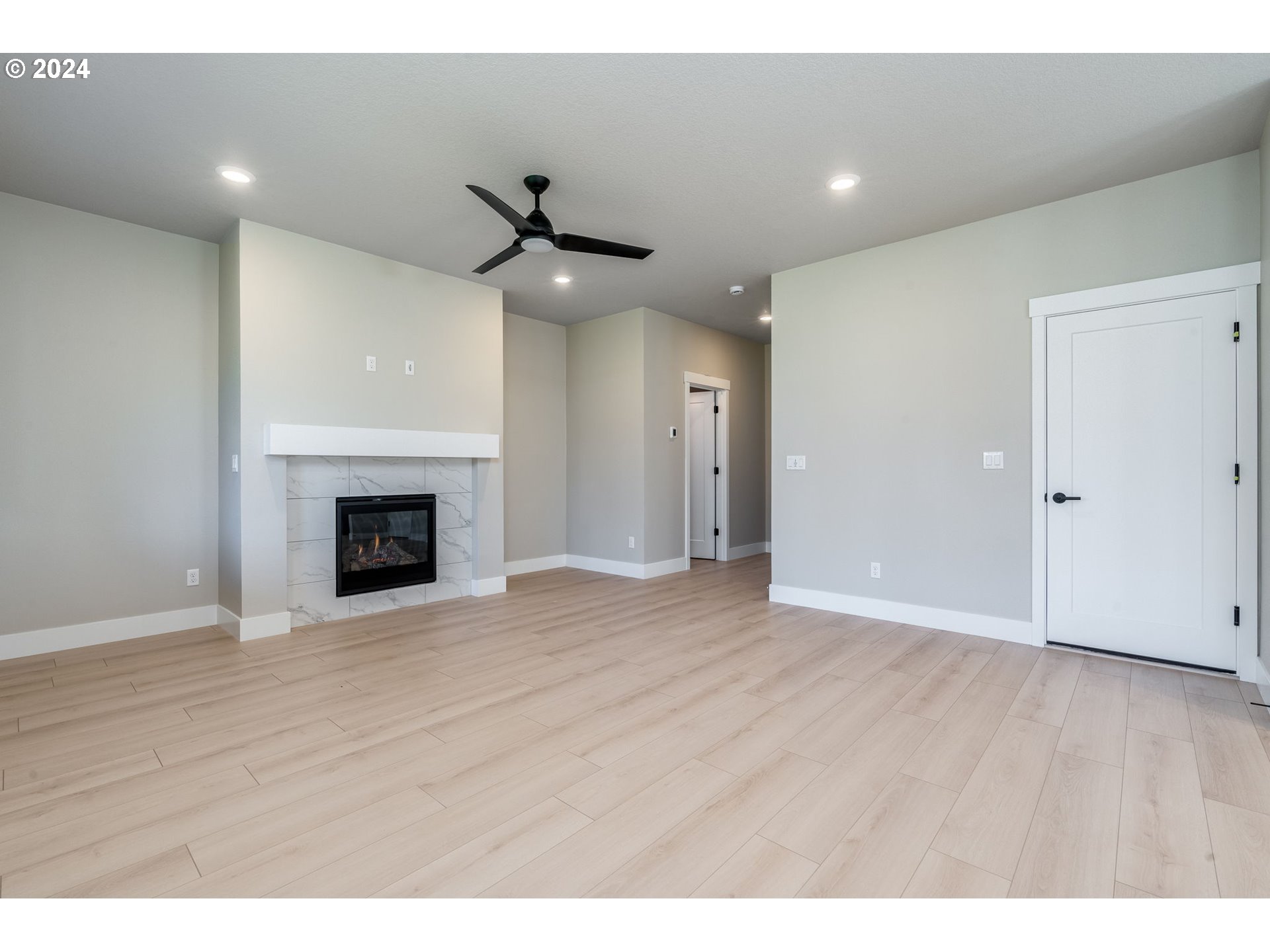 3703 South Arwana Lane Ridgefield, WA 98642 - Photo 15 of 35 a view of an empty room with wooden floor fireplace and a window