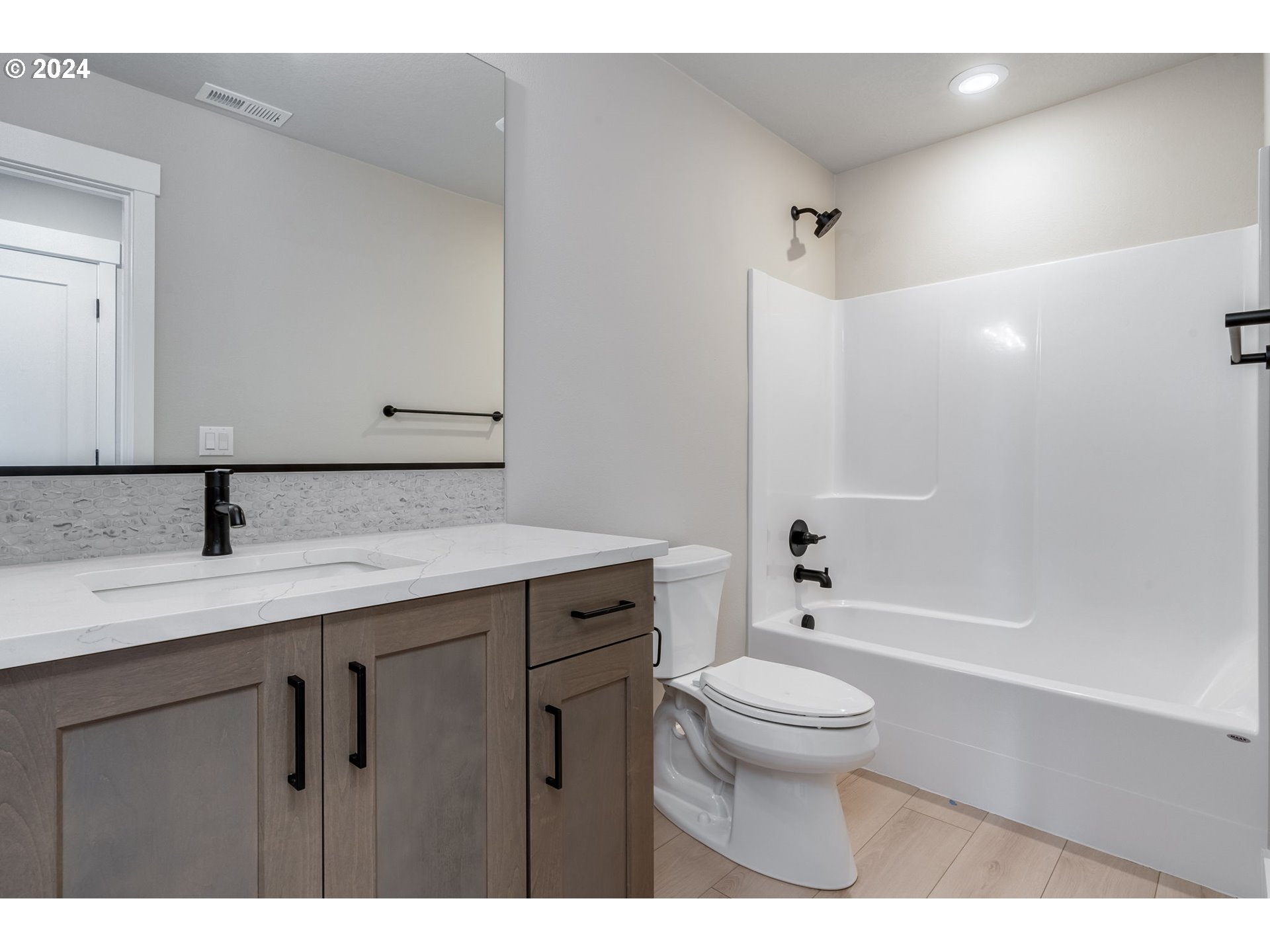 3703 South Arwana Lane Ridgefield, WA 98642 - Photo 33 of 35 a bathroom with a granite countertop sink a toilet and a large mirror