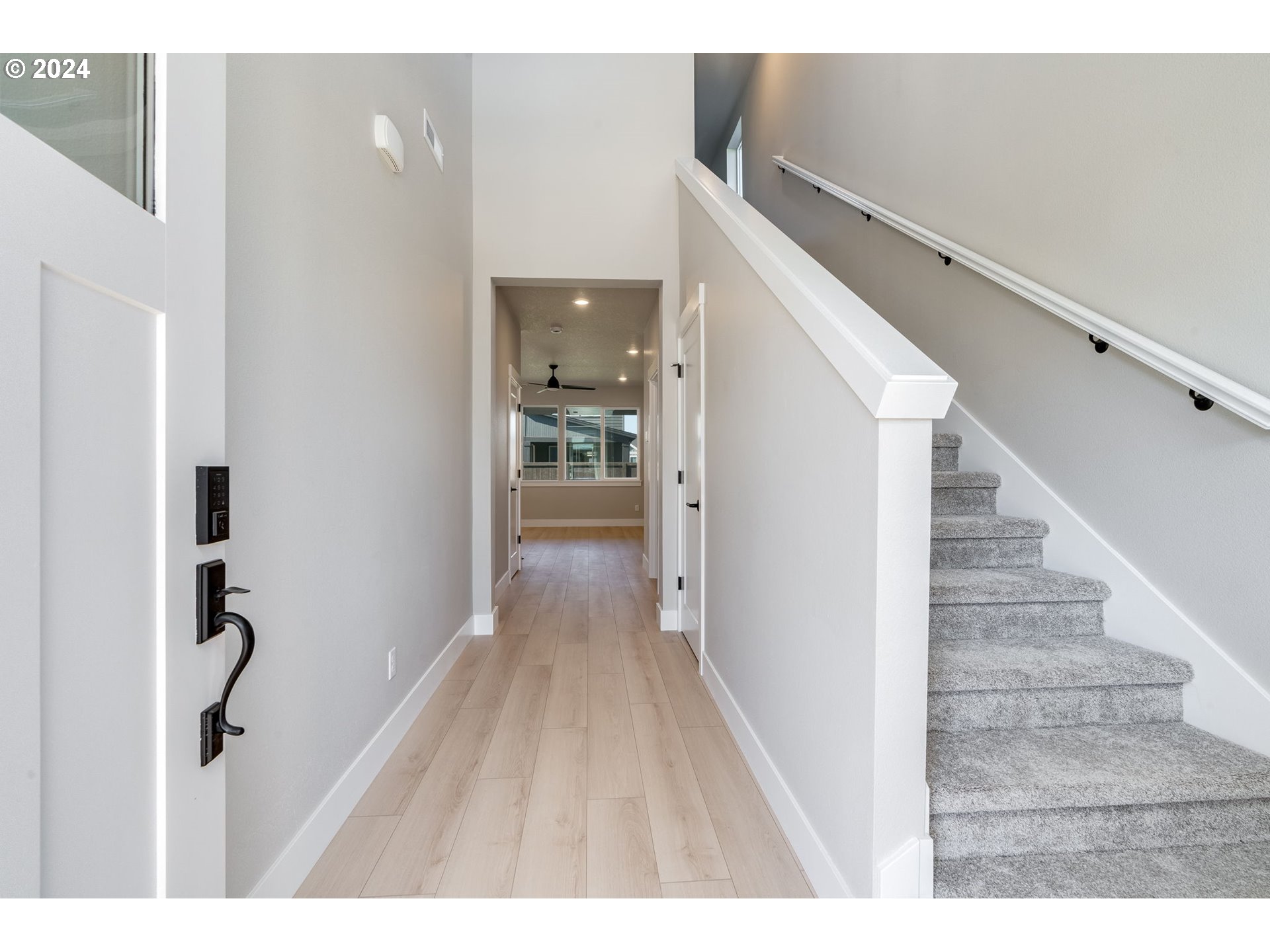 3703 South Arwana Lane Ridgefield, WA 98642 - Photo 9 of 35 a view of a hallway with wooden floor and staircase
