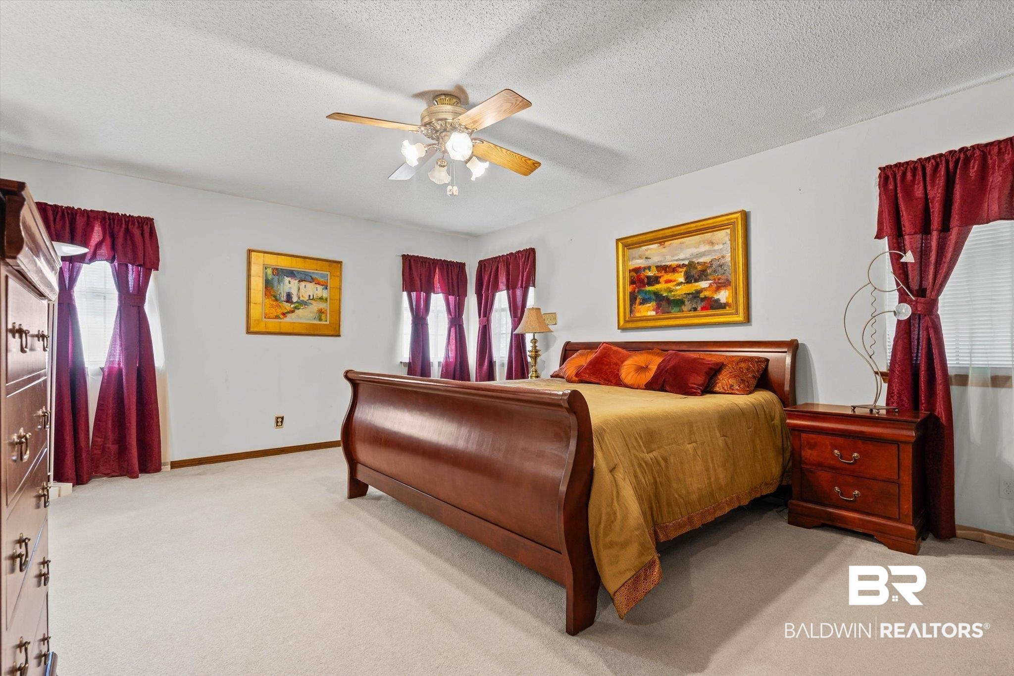 1900 Foxfire Road Mobile, AL 36618 - Photo 13 of 36 Bedroom with light carpet, a textured ceiling, and ceiling fan