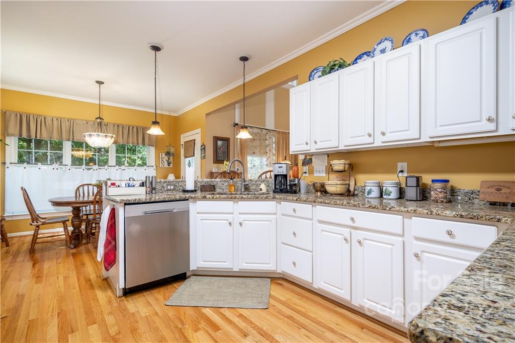 7545 Windy Pine Circle, Unit 30 Denver, NC 28037 - Photo 11 of 38 a kitchen with stainless steel appliances granite countertop a stove a sink and white cabinets with wooden floor