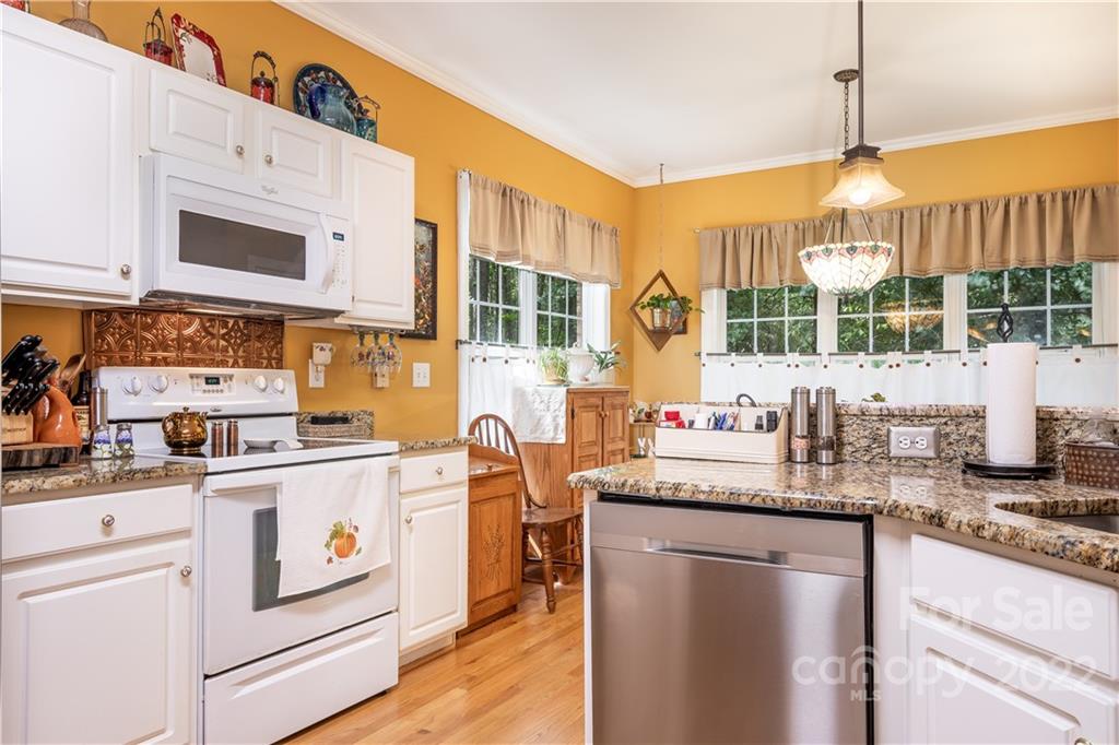 7545 Windy Pine Circle, Unit 30 Denver, NC 28037 - Photo 13 of 38 a kitchen with stainless steel appliances granite countertop a stove and a white cabinets