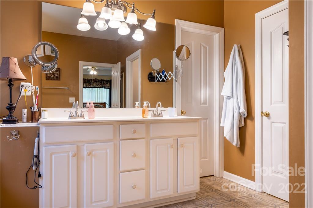 7545 Windy Pine Circle, Unit 30 Denver, NC 28037 - Photo 16 of 38 a bathroom with a sink vanity and a mirror