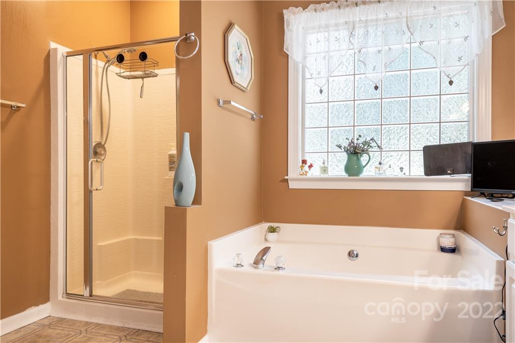 7545 Windy Pine Circle, Unit 30 Denver, NC 28037 - Photo 17 of 38 a bathroom with a bathtub a shower and a window