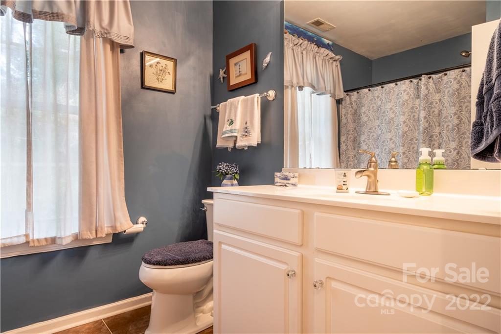 7545 Windy Pine Circle, Unit 30 Denver, NC 28037 - Photo 19 of 38 a bathroom with a sink and a mirror
