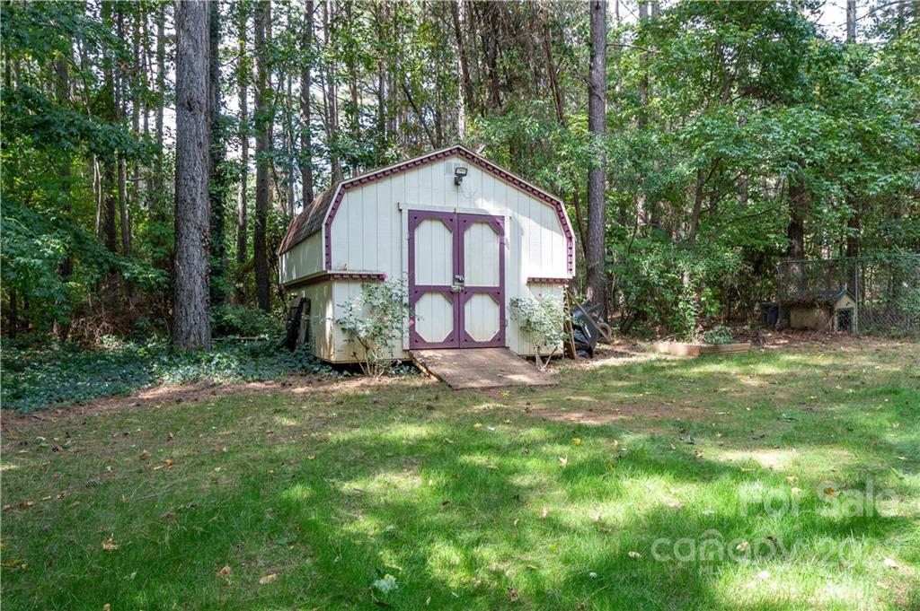 7545 Windy Pine Circle, Unit 30 Denver, NC 28037 - Photo 26 of 38 a view of a wooden house with a yard and large trees