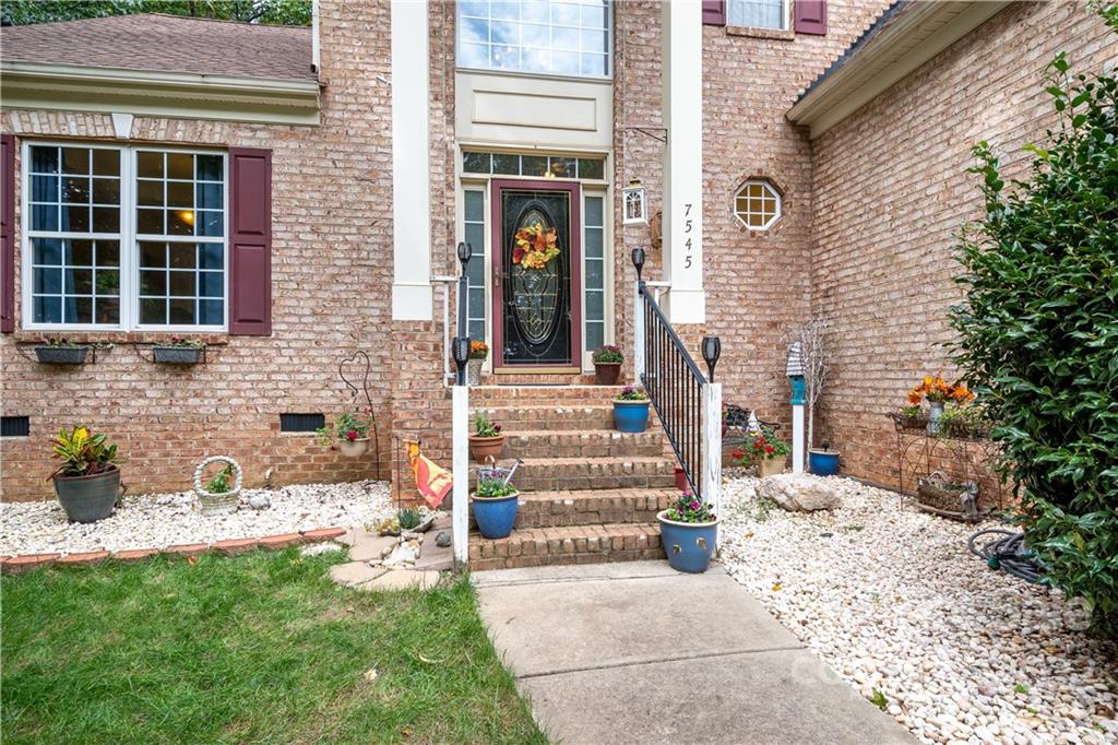 7545 Windy Pine Circle, Unit 30 Denver, NC 28037 - Photo 3 of 38 a front view of a house with a garden