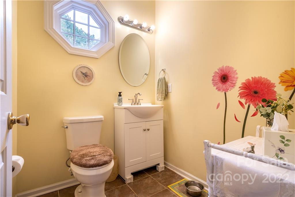 7545 Windy Pine Circle, Unit 30 Denver, NC 28037 - Photo 9 of 38 a bathroom with a sink mirror and toilet