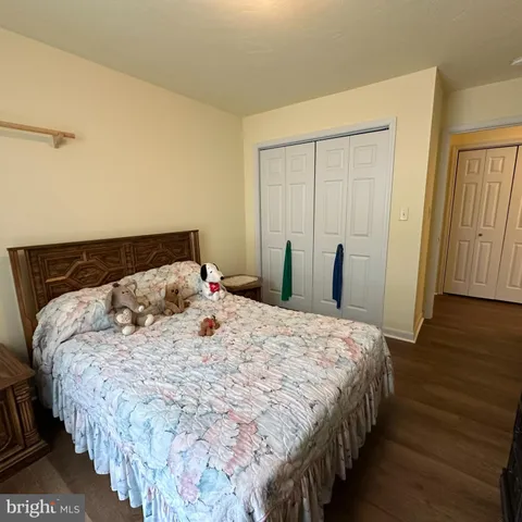 a bedroom with a large bed chandelier and a window