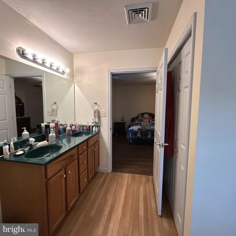 a view of hallway with wooden floor