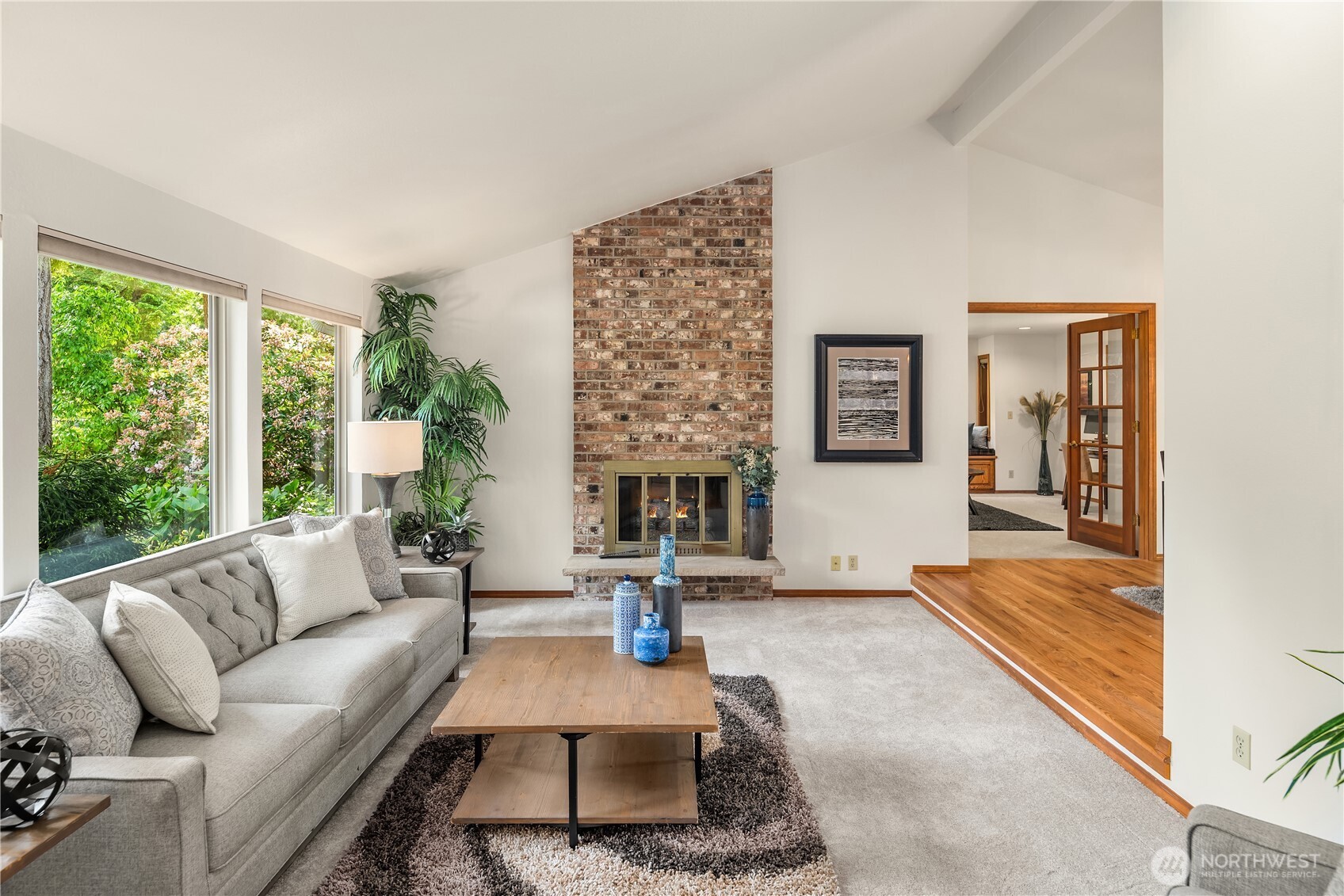 22809 38th Avenue Southeast Bothell, WA 98021 - Photo 2 of 40 a living room with furniture large window and a fireplace