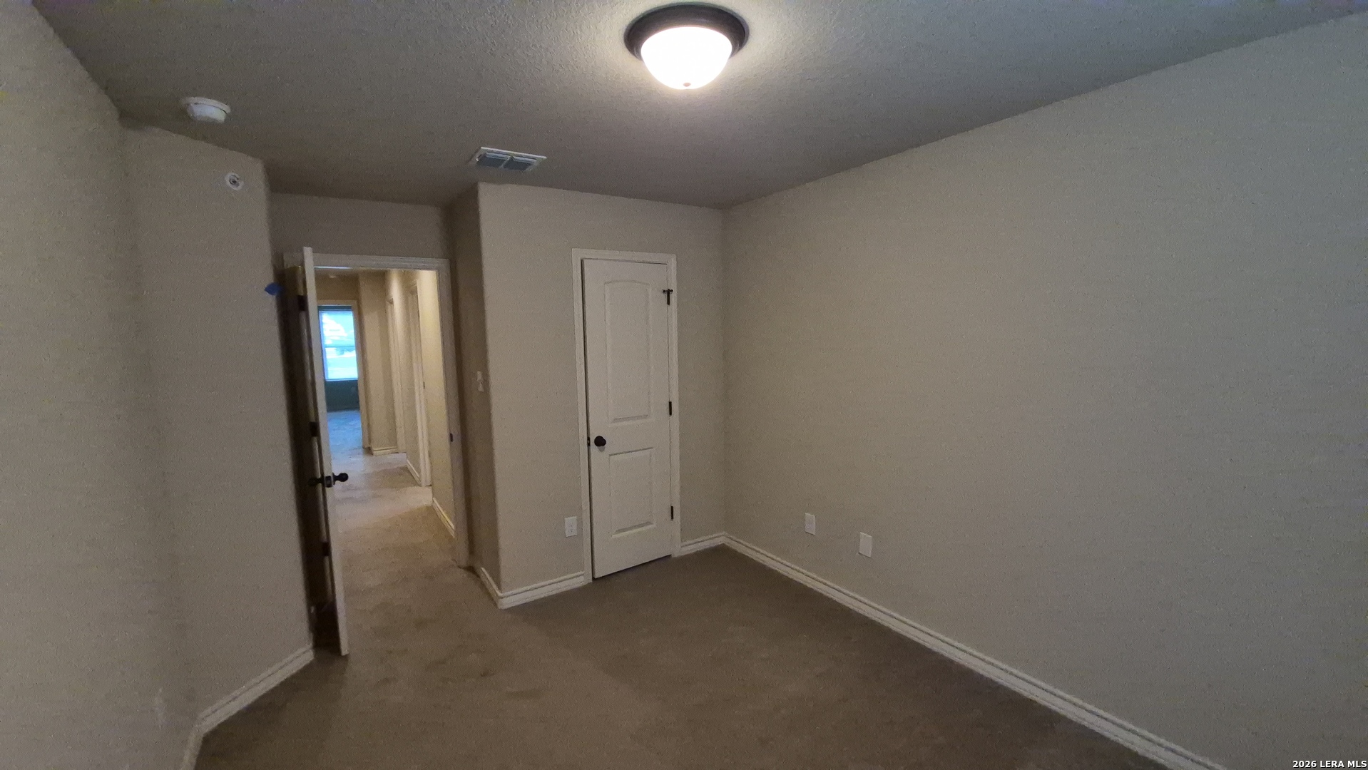 6414 Luglio Lane, Unit 101 San Antonio, TX 78233 - Photo 21 of 23 an empty room with closet and mirror