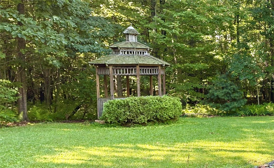 1222 Spring Road Andreas, PA 18211 - Photo 38 of 38 A secluded wooden gazebo nestled among mature trees offers a tranquil retreat in the verdant yard.