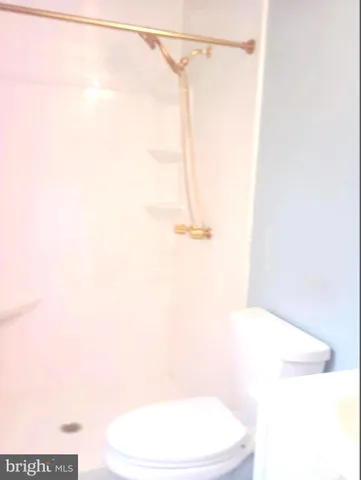 a bathroom with a white bathtub and a shower