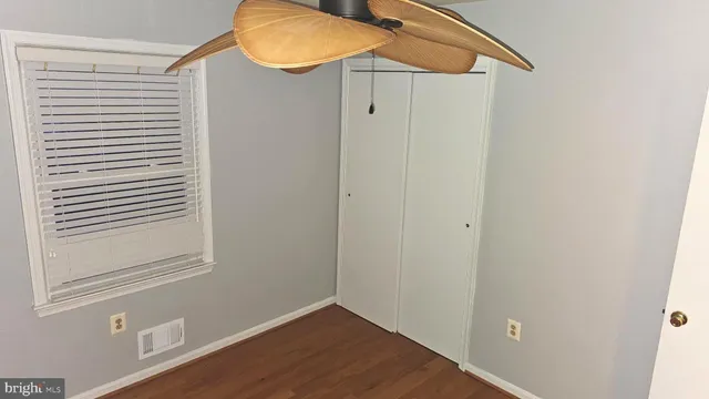 a view of a small space with wooden floor and a window