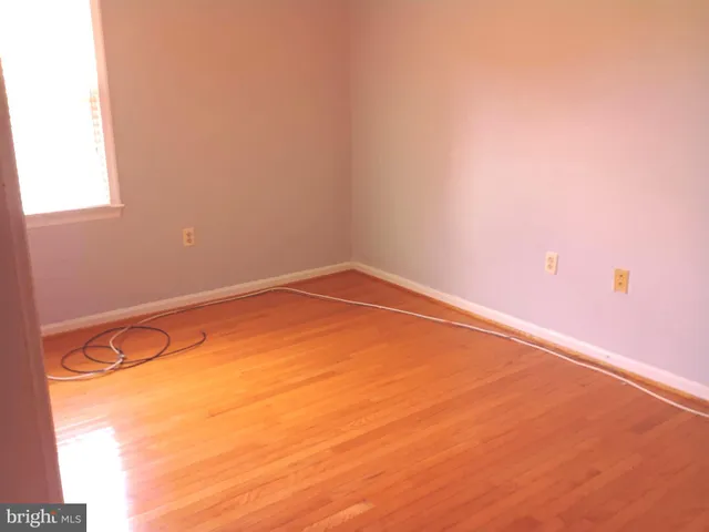 a view of a room with an empty space and a window