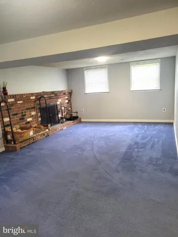 a view of a livingroom with furniture and a window