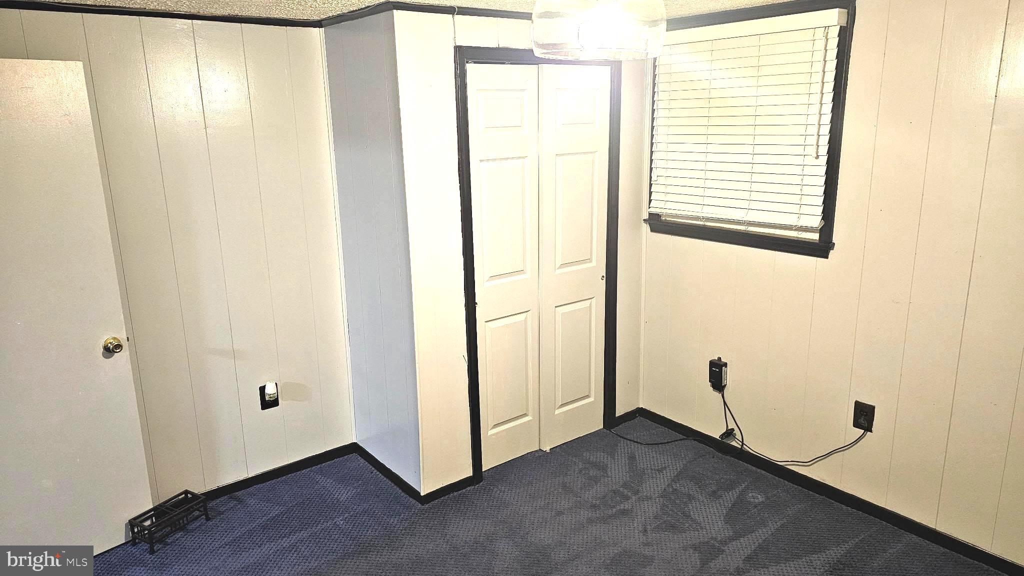 11603 Butlers Branch Road Clinton, MD 20735 - Photo 32 of 42 a view of an empty room with wooden floor and a window
