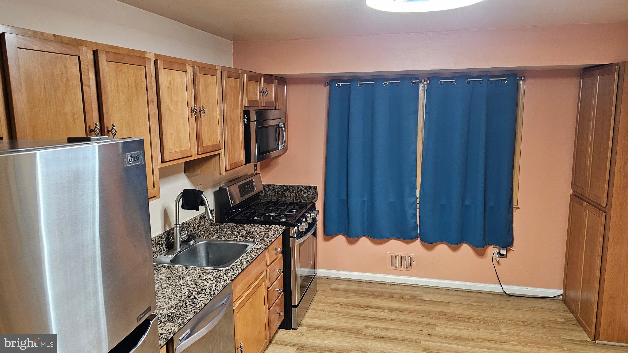 11603 Butlers Branch Road Clinton, MD 20735 - Photo 4 of 42 a kitchen with a refrigerator and a stove top oven