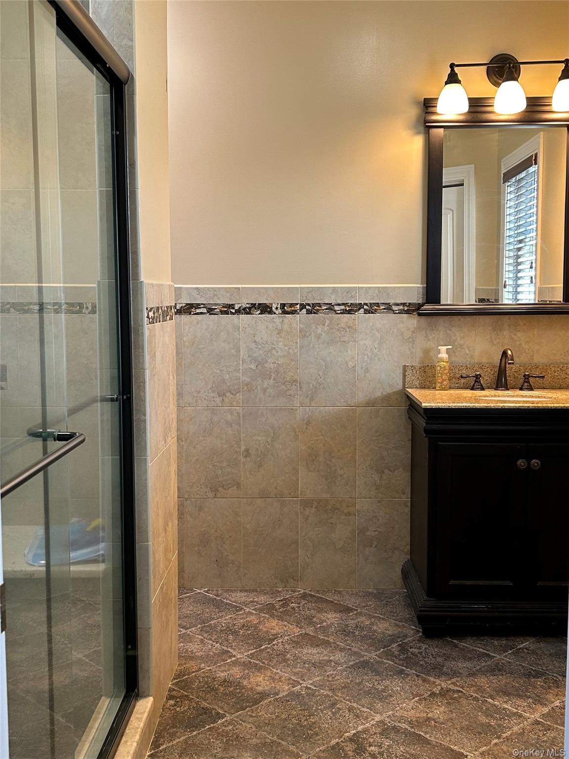 4 Vining Street Centereach, NY 11720 - Photo 18 of 26 a bathroom with a sink and a mirror