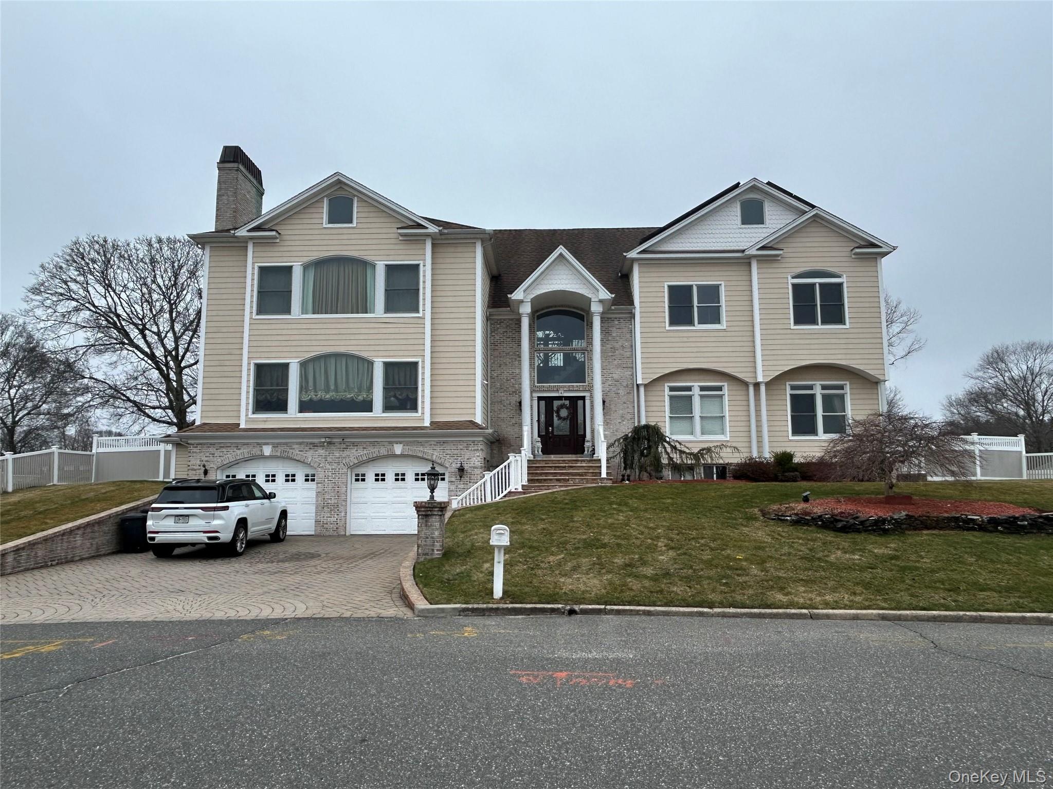 4 Vining Street Centereach, NY 11720 - Photo 4 of 26 a front view of a house with cars parked