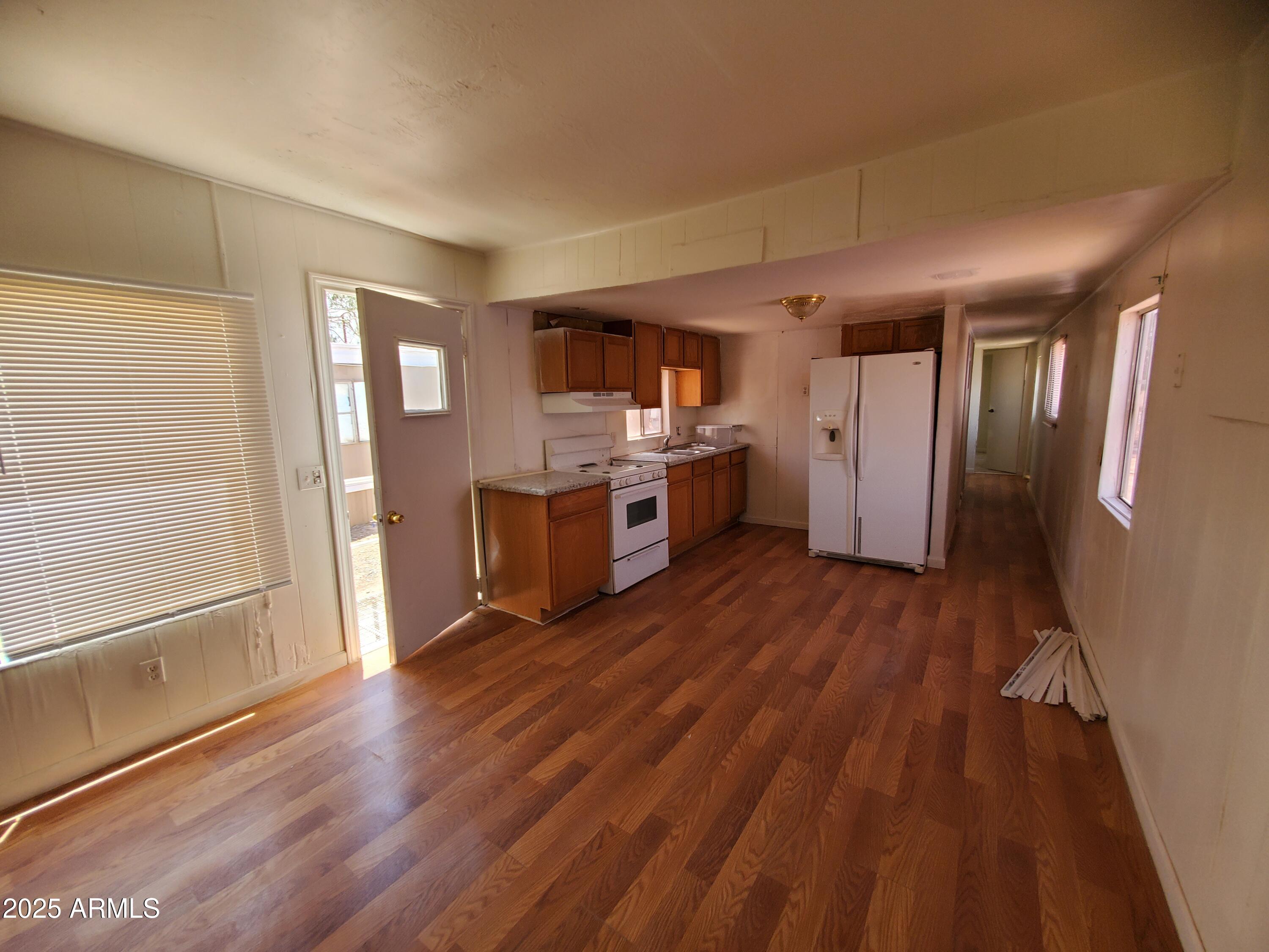 799 West Battaglia Road, Unit 22 Eloy, AZ 85131 - Photo 2 of 9 a kitchen with a hard wood floor