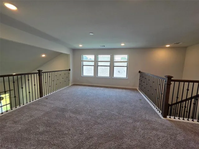 a view of hallway with windows