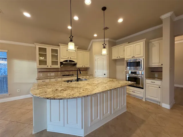 a kitchen with kitchen island a sink stainless steel appliances and cabinets