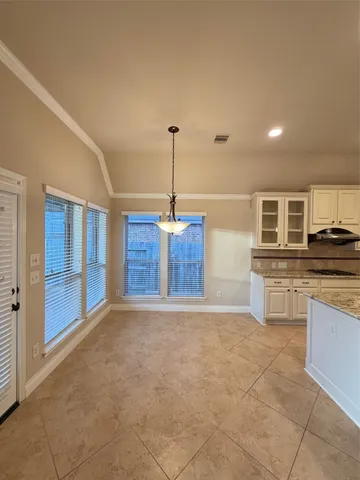 a view of a kitchen with stainless steel appliances granite countertop a stove and a sink