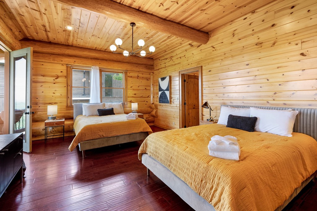 502 Overlook Drive Blue Ridge, GA 30513 - Photo 27 of 53 a bedroom with a bed and wooden floor