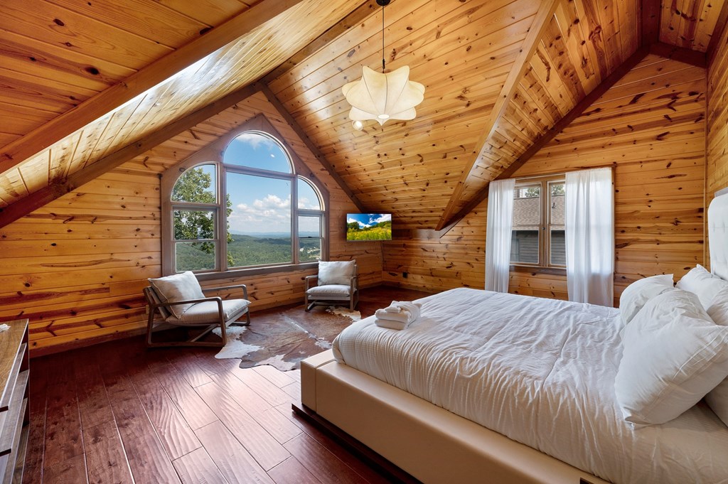 502 Overlook Drive Blue Ridge, GA 30513 - Photo 35 of 53 a bedroom with a bed couch and a fireplace