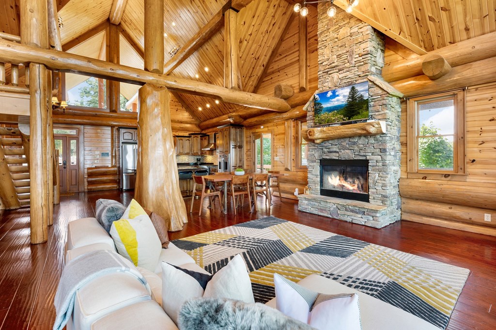502 Overlook Drive Blue Ridge, GA 30513 - Photo 10 of 53 a view of a livingroom with furniture a fireplace a rug a fireplace a chandelier and windows