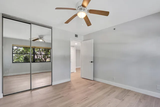 a view of entryway with a ceiling fan and wooden floor