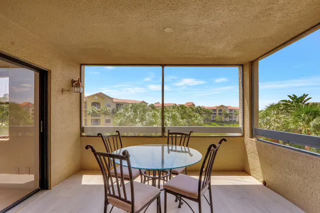 a view of a porch with furniture and a yard