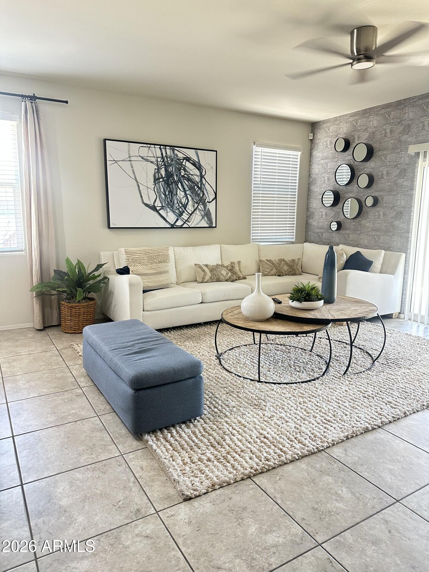 7851 West Riverside Avenue Phoenix, AZ 85043 - Photo 4 of 40 a living room with furniture and a painting on the wall
