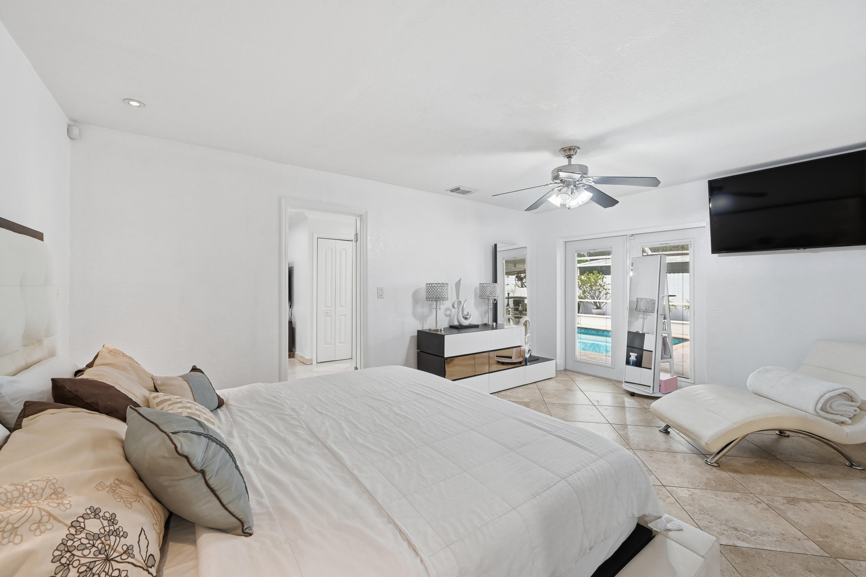 6271 Harding Street Hollywood, FL 33024 - Photo 13 of 58 a bedroom with a bed and a flat screen tv