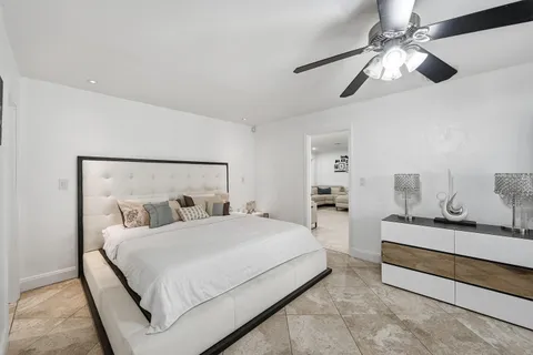 a bedroom with a bed and ceiling fan