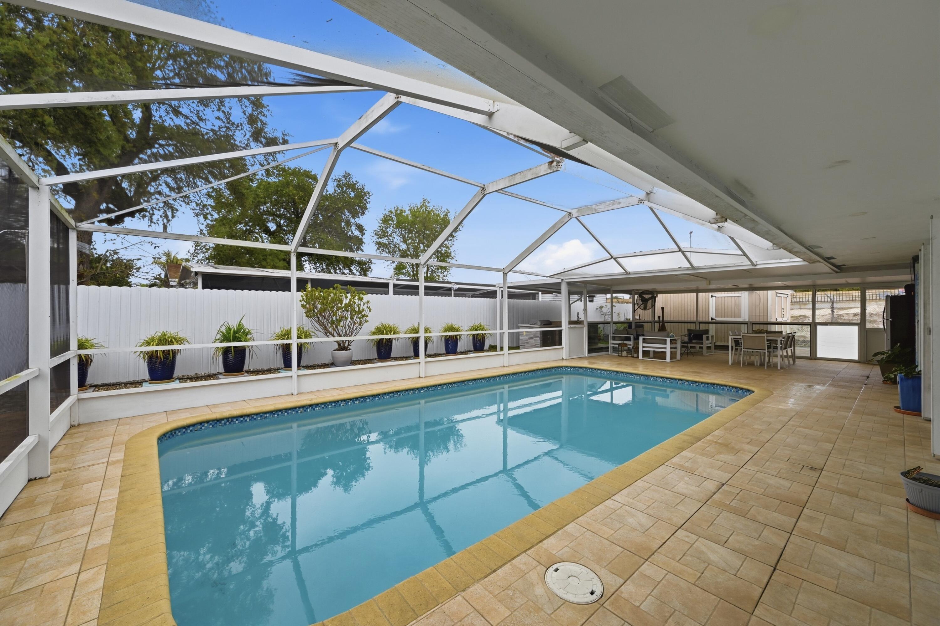 6271 Harding Street Hollywood, FL 33024 - Photo 25 of 58 a view of a swimming pool with seating area