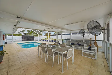 a swimming pool with outdoor seating