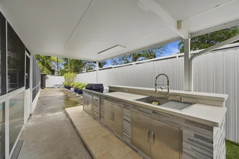 a view of house with outdoor space and swimming pool